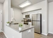 Thumbnail 1 of 30 - a kitchen with stainless steel appliances and a large counter top