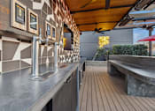 Thumbnail 21 of 31 - A modern bar with a wooden floor and a metal counter.