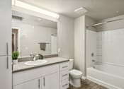 Thumbnail 11 of 30 - a bathroom with a sink toilet and a tub