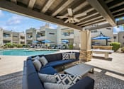 Thumbnail 9 of 21 - A patio with a pool and a blue couch.