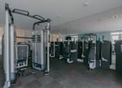 Thumbnail 12 of 23 - A gym with a row of treadmilers.
