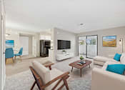 Thumbnail 4 of 30 - A living room with a white couch and a wooden coffee table.