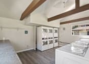 Thumbnail 11 of 22 - a kitchen with white appliances and a large window