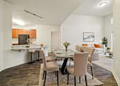 Thumbnail 3 of 19 - A modern dining room with a table set for four.