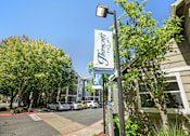 Thumbnail 23 of 27 - A street view of a building with a sign that says "Trinity's".