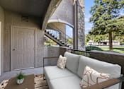 Thumbnail 9 of 20 - a patio with a couch and a table and a door