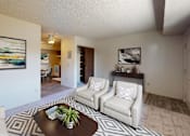 Thumbnail 5 of 15 - a living room with a couch and a coffee table