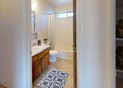 Thumbnail 8 of 15 - a bathroom with a sink and a toilet and a shower