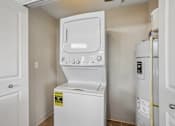 Thumbnail 15 of 27 - A white dishwasher and refrigerator in a small kitchen.