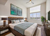 Thumbnail 23 of 24 - A bedroom with a large bed and a painting above it.