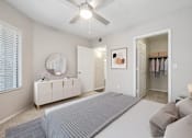 Thumbnail 13 of 33 - a bedroom with a large bed and a ceiling fan