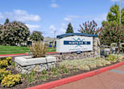 Thumbnail 20 of 20 - the sign in front of a brick sidewalk and grass