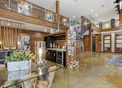 Thumbnail 21 of 42 - A modern interior with a wooden staircase and a glass table.