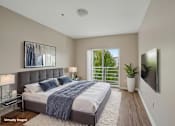 Thumbnail 10 of 27 - A bedroom with a large bed and a flat screen TV mounted on the wall.