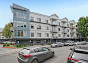 Thumbnail 27 of 27 - A parking lot with cars and apartment buildings.