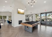 Thumbnail 18 of 24 - A room with a pool table and a fireplace.