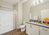 Thumbnail 9 of 28 - A white bathroom with a toilet, sink, and shower.