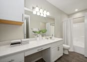 Thumbnail 7 of 20 - a bathroom with a sink and a toilet