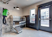 Thumbnail 30 of 34 - a laundry room with a sink and a door to a street