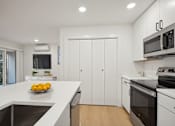Thumbnail 8 of 32 - A kitchen with a bowl of lemons on the counter.