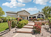 Thumbnail 23 of 24 - A house with a garden in front of it.