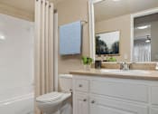 Thumbnail 8 of 22 - a bathroom with a toilet and a sink and a shower