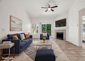Thumbnail 5 of 27 - A living room with a blue couch and a painting on the wall.