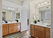 Thumbnail 7 of 23 - a large bathroom with two sinks and a mirror