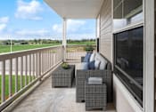 Thumbnail 7 of 16 - a covered porch with a couch and chairs and a tv