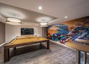 Thumbnail 15 of 28 - a game room with a pool table and a mural on the wall