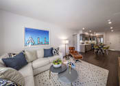 Thumbnail 10 of 28 - a living room with a couch and a table