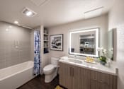 Thumbnail 7 of 28 - a bathroom with a shower toilet and sink