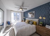 Thumbnail 3 of 28 - a bedroom with blue wallpaper and a white bed