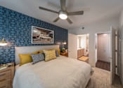 Thumbnail 2 of 28 - a bedroom with a large bed and a ceiling fan
