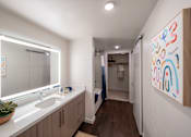 Thumbnail 4 of 28 - a bathroom with a large mirror and a sink