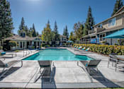 Thumbnail 16 of 32 - Swimming Pool With Lounge Chairs at Atwood Apartments, Citrus Heights, CA
