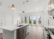 Thumbnail 19 of 20 - A modern kitchen with white countertops and dark brown cabinets.