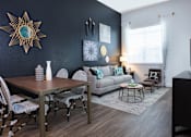 Thumbnail 5 of 24 - a living and dining room area with a couch table and chairs and a tv on a stand