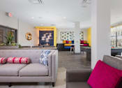 Thumbnail 15 of 24 - a living room with couches and chairs
