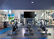 Thumbnail 13 of 24 - a spacious fitness center with treadmills and exercise bikes