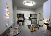 Thumbnail 20 of 20 - A kitchen with a neon sign hanging above the counter.