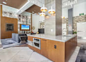 Thumbnail 34 of 40 - a kitchen with a large island and a living room with a fireplace