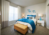 Thumbnail 5 of 31 - a bedroom with a large bed and blue and white bedding