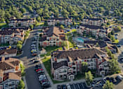 Thumbnail 30 of 31 - an aerial view of a neighborhood with houses and cars parked