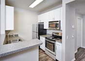 Thumbnail 2 of 31 - a kitchen with stainless steel appliances and white cabinets
