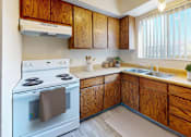 Thumbnail 2 of 15 - a kitchen with a stove and a sink
