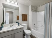 Thumbnail 5 of 18 - a bathroom with a sink toilet and a shower