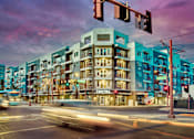Thumbnail 29 of 29 - A street view of a city with a multi-story building with a sign that says "CENTRA" on it.
