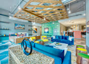 Thumbnail 3 of 29 - A modern living room with a blue sofa and a wooden ceiling.