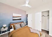 Thumbnail 6 of 30 - a bedroom with a bed and a ceiling fan